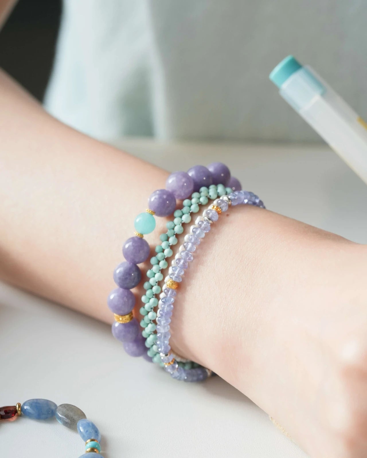 Close-up of chalcedony and amazonite bracelet with gold-plated accents