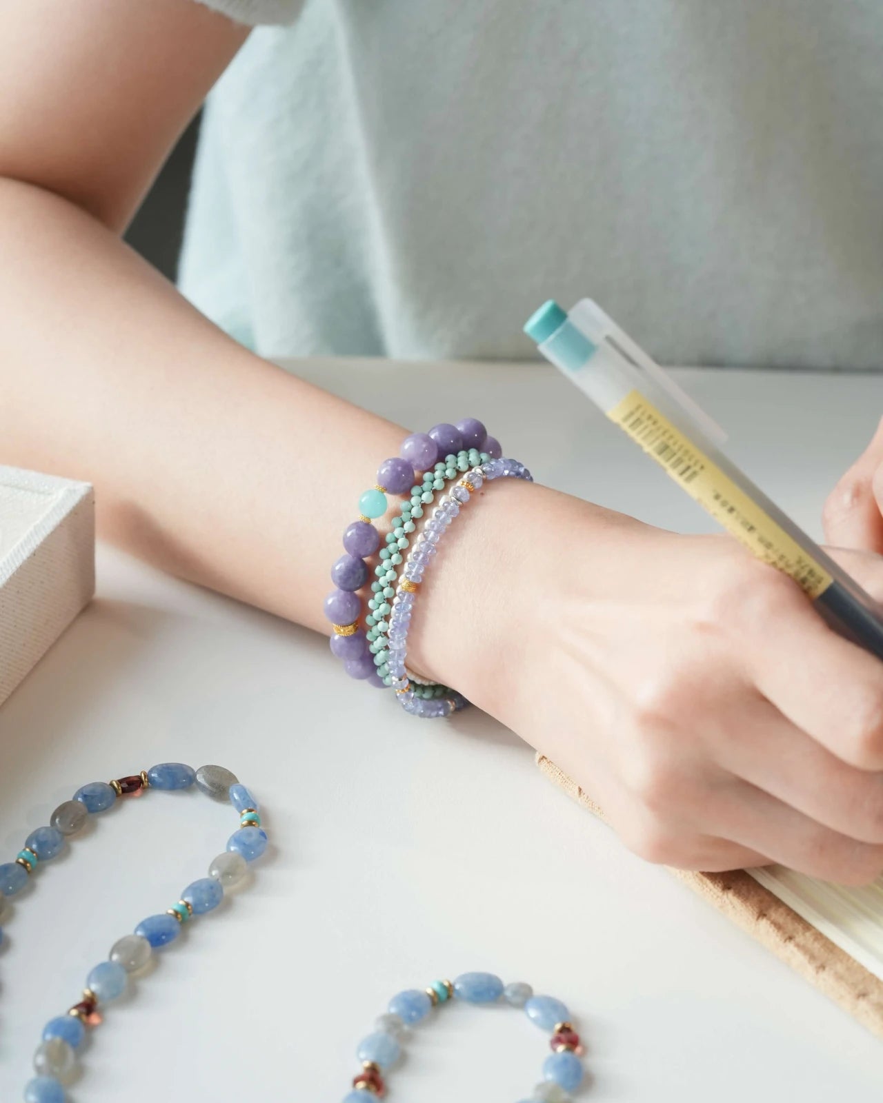 Lavender Tide Serenity Bracelet — Purple Chalcedony & Amazonite on wrist while writing