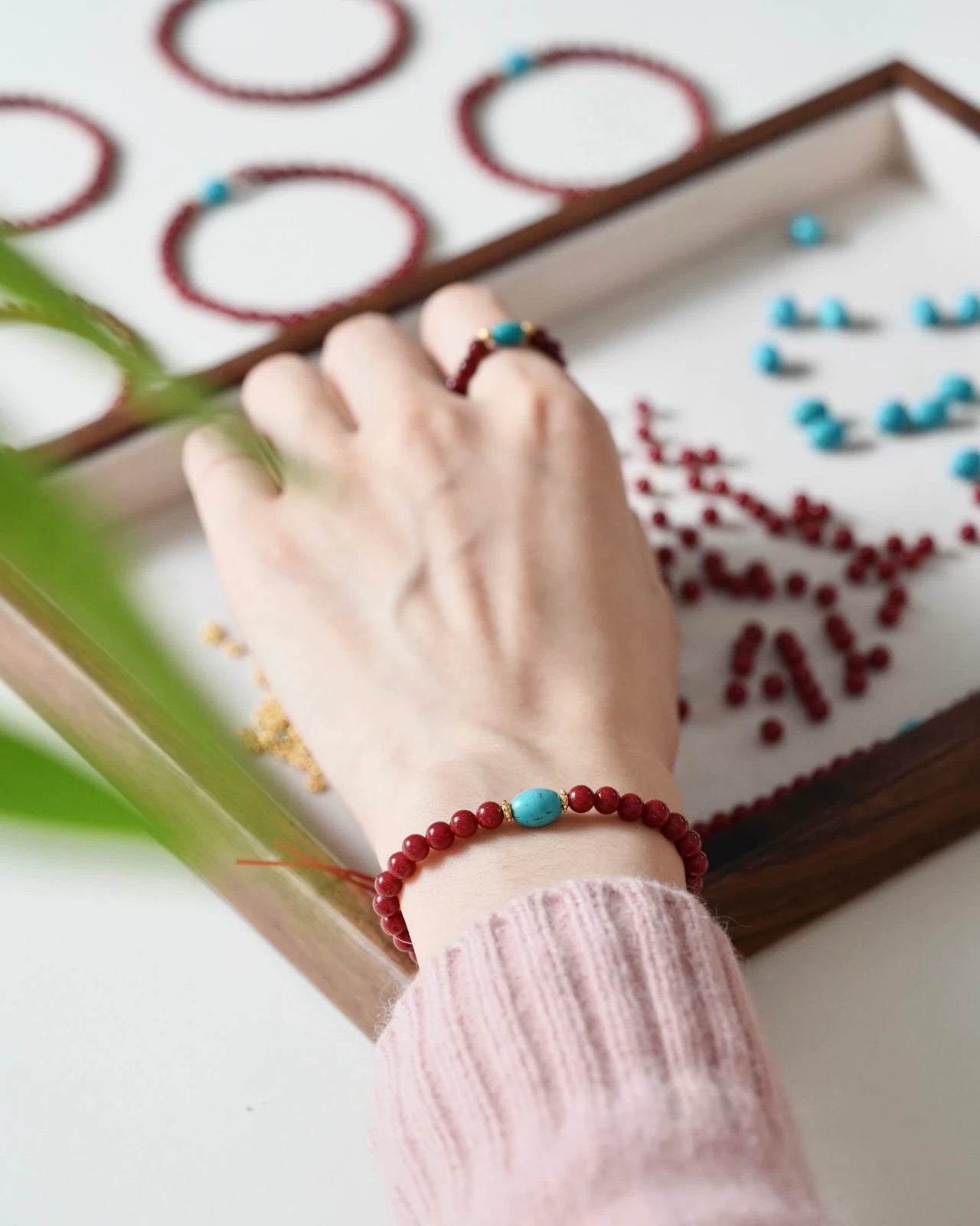Close-up of cinnabar and turquoise beads, healing crystal jewelry