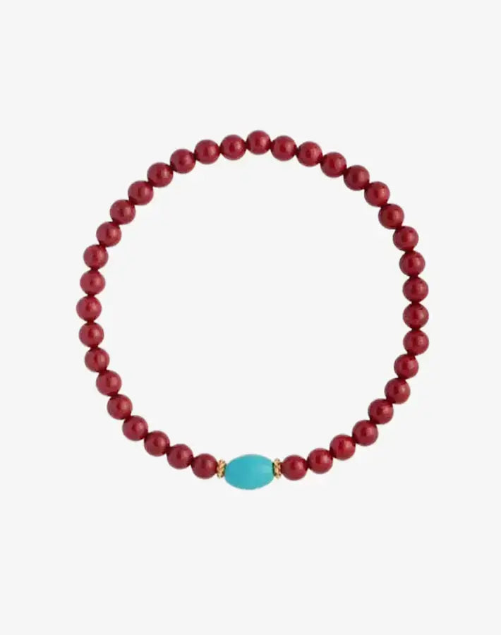 Crimson Sky Prosperity bracelet with cinnabar and turquoise beads and gold-plated S925 silver spacers laid flat on a gray background.