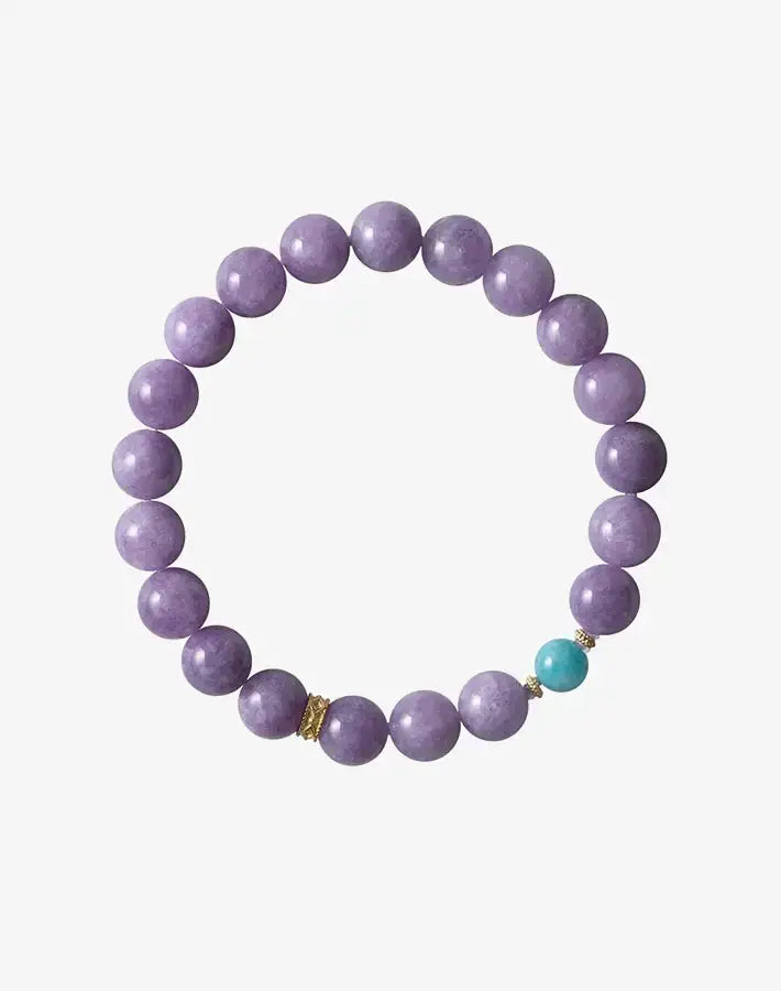 Lavender Tide Serenity bracelet laid flat on a gray background, featuring purple chalcedony and amazonite beads with gold-plated S925 silver spacers.