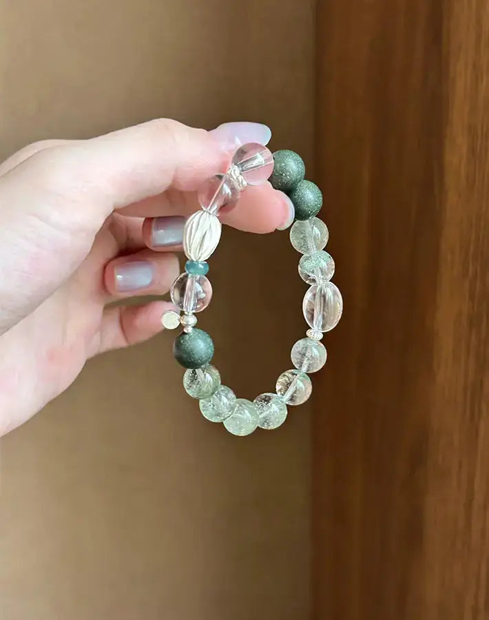 Close-up showing jadeite and green phantom quartz framed by incense beads and silver spacers on the Serenity Alignment bracelet.